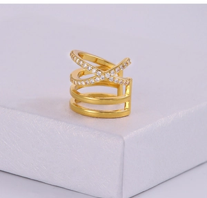 Détail macro de la bague d'oreille croisée dorée ornée de micro-oxydes de zirconium pavés