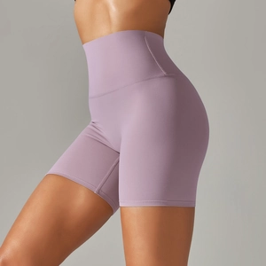 Detail of high-waisted lilac yoga shorts showing elastic fabric and lifting effect