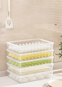 Detailed view of 5-tier stackable transparent dumpling storage boxes with white lids