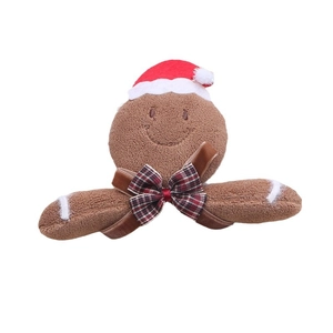 Cute plush Christmas gingerbread man doll with hat and bow tie on white background