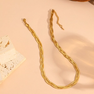 Detail of layered gold braided necklace with lobster clasp and extension chain