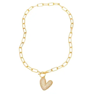 Gold paperclip chain necklace with a sparkling pavé heart pendant and decorative toggle clasp