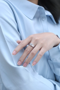 Close-up of a silver moissanite ring on male hand with high polished metallic texture