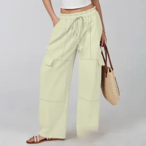 Detail view of the drawstring elastic high waist and pockets on cotton linen wide leg pants