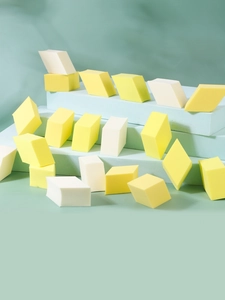 Detailed view of non-latex diamond makeup sponges in yellow and white on display