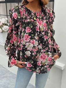 Detail of floral printed shirt with smocked chest and elegant ruffled shoulders
