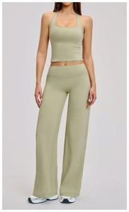 Full body view of light sage green square neck sports tank and wide leg yoga pants set
