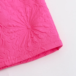 Pink mini dress with floral embossed texture and delicate ruffled hem detail