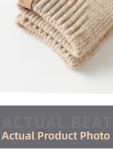 Detailed macro of thick ribbed knit fabric and leather patch on warm winter gloves