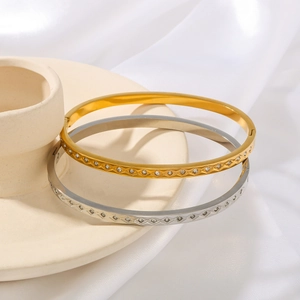 Bracciali in acciaio placcati oro 18K con motivo a rombi e diamanti in oro e argento