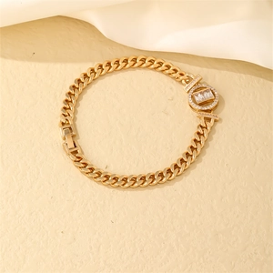 Close-up of gold Cuban link bracelet featuring rectangular baguette zircon center stone
