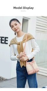 Fashionable pink leather and straw bucket bag with drawstring closure on female model