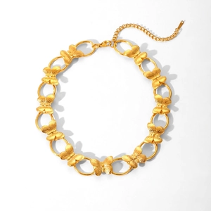 Detailed view of golden butterfly necklace with brushed texture and lobster clasp