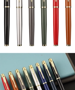 Close-up of multicolored metal rollerball pens with golden arrow clips on a notebook