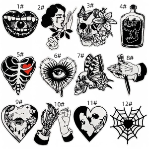 Macro detail of gothic punk embroidery patches featuring skull and heart designs