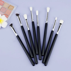 Detailed top view of 8-piece professional eye makeup brush set with black wooden handles