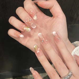 Close-up of pink cat eye press-on nails with hand-painted flowers and pearl accents