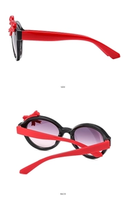 Detail view showing red bow accent and purple gradient lenses on children's sunglasses