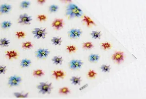 Detailed macro view of 5D floral nail stickers with blue and purple watercolor flower patterns