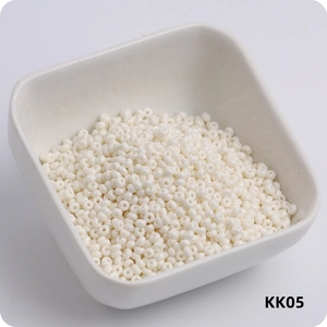 Macro shot of 3mm cream white glass seed beads in a white ceramic bowl model KK05