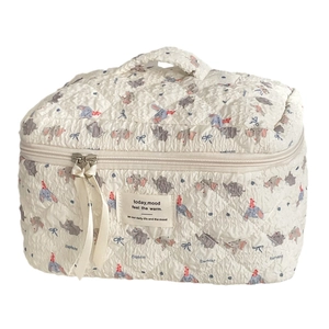 Quilted elephant makeup bag with red hat and dual zippers for travel storage