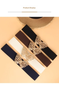 Detail of four elastic waist belts with golden butterfly buckles in assorted colors