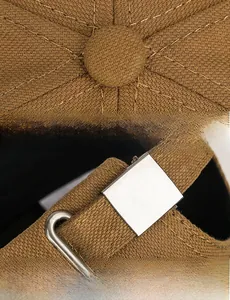 Detail of cotton baseball cap showing crown stitching and adjustable silver metal buckle