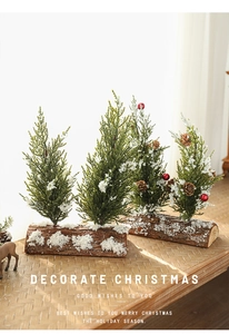 Close-up of mini snow-covered Christmas trees with pine cones on a rustic wooden base