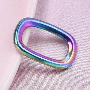 Macro shot of an oval geometric 304 stainless steel pendant with rainbow plating finish