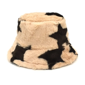 Close-up of beige faux rabbit fur bucket hat featuring black star patterns and soft texture