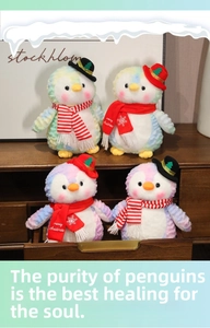 Detail showing colorful macaron tie-dye plush penguins with festive Christmas hats and scarves