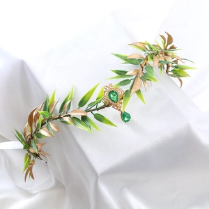 Baroque gold leaf headband with green teardrop crystal on soft white silk fabric