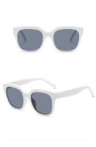 Macro view of square oversized white sunglasses with grey lenses and retro design