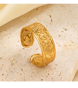 Close-up of golden vintage embossed texture on adjustable stainless steel ring