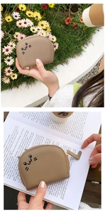 Close-up of cat face embroidery on khaki card wallet with golden L-shaped zipper