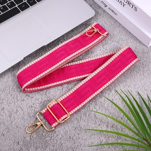 Ethnic style pink woven bag strap with geometric patterns and gold metal buckles