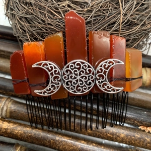 Handmade orange raw crystal hair comb featuring a silver triple moon goddess ornament