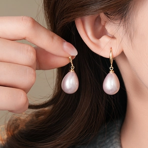 Elegant gold drop earrings with pink teardrop pearls in a vintage minimalist style