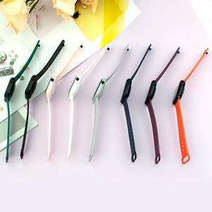 Flat lay of eight colorful silicone watch straps in a stylish minimalist setting