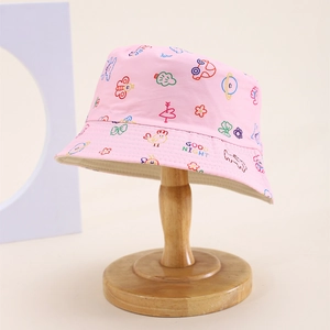 Detail of pink cotton sun hat for kids featuring colorful cartoon prints and wide brim