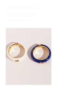 Detail of blue and white enamel adjustable rings with rectangular cubic zirconia stones