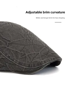 Macro shot of flexible wide brim on a dark gray newsboy cap with textured fabric details