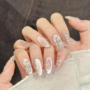 Champagne pink cat eye press-on nails with luxury rhinestones and almond shape