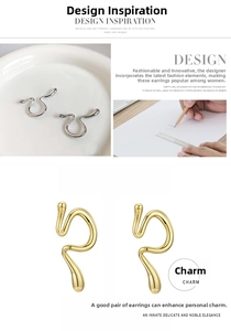 Detail view of irregular curved line earrings in gold and silver finishes