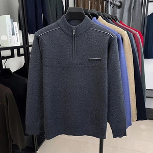 Detail view of various colors of men's half-zip knit sweaters on hangers