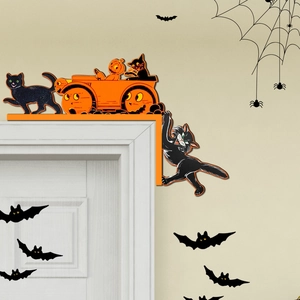 Detail of wooden Halloween door corner decor featuring black cats and pumpkin carriage