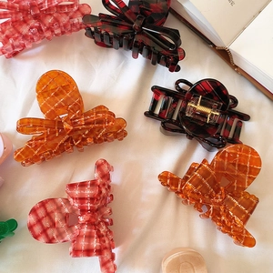 Elegant acetate hair claws with red plaid ribbon bow design for stylish updo hairstyles