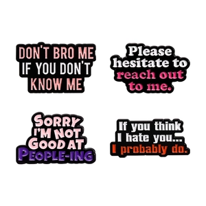 Set of four colorful enamel lapel pins with funny motivational English quotes for backpacks