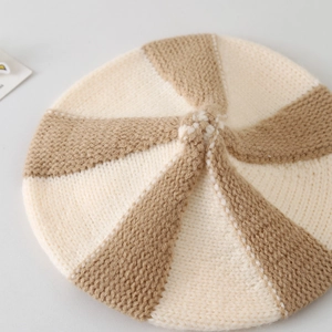 Close-up of the beige and brown striped knitted texture and pattern of the baby beret