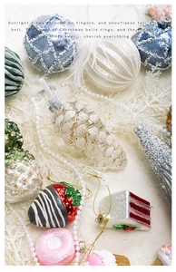 Detail of Christmas tree ornaments featuring glittery pine cones and dessert shapes
